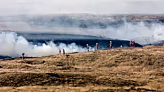 Fire fighters dealing with a large grassfire on an upland moors in Wales