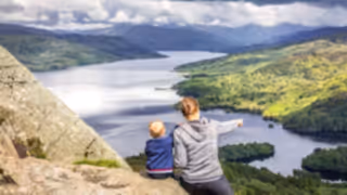 Mom and boy watching Loch Katrine, Scotland.