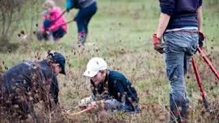 Young volunteers clearing scrub at the RSPB Vange Marsh near Basildon, Essex